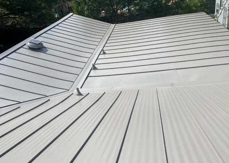 Solar attic fan installed on a metal roof for Roof Ventilation in Albert Lea