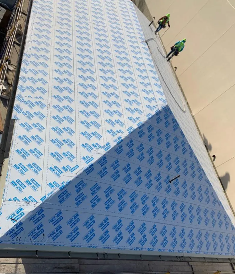 Professional roofers installing underlayment on a metal roof in Albert Lea